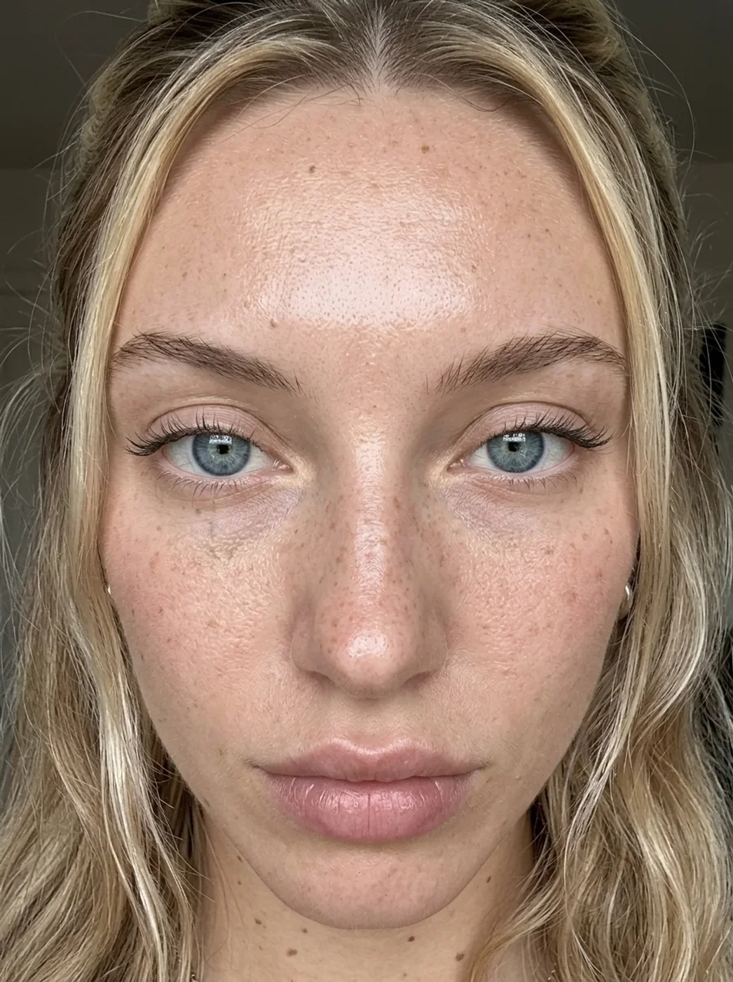 Extreme close-up of the avatar's face showing freckles and skin texture